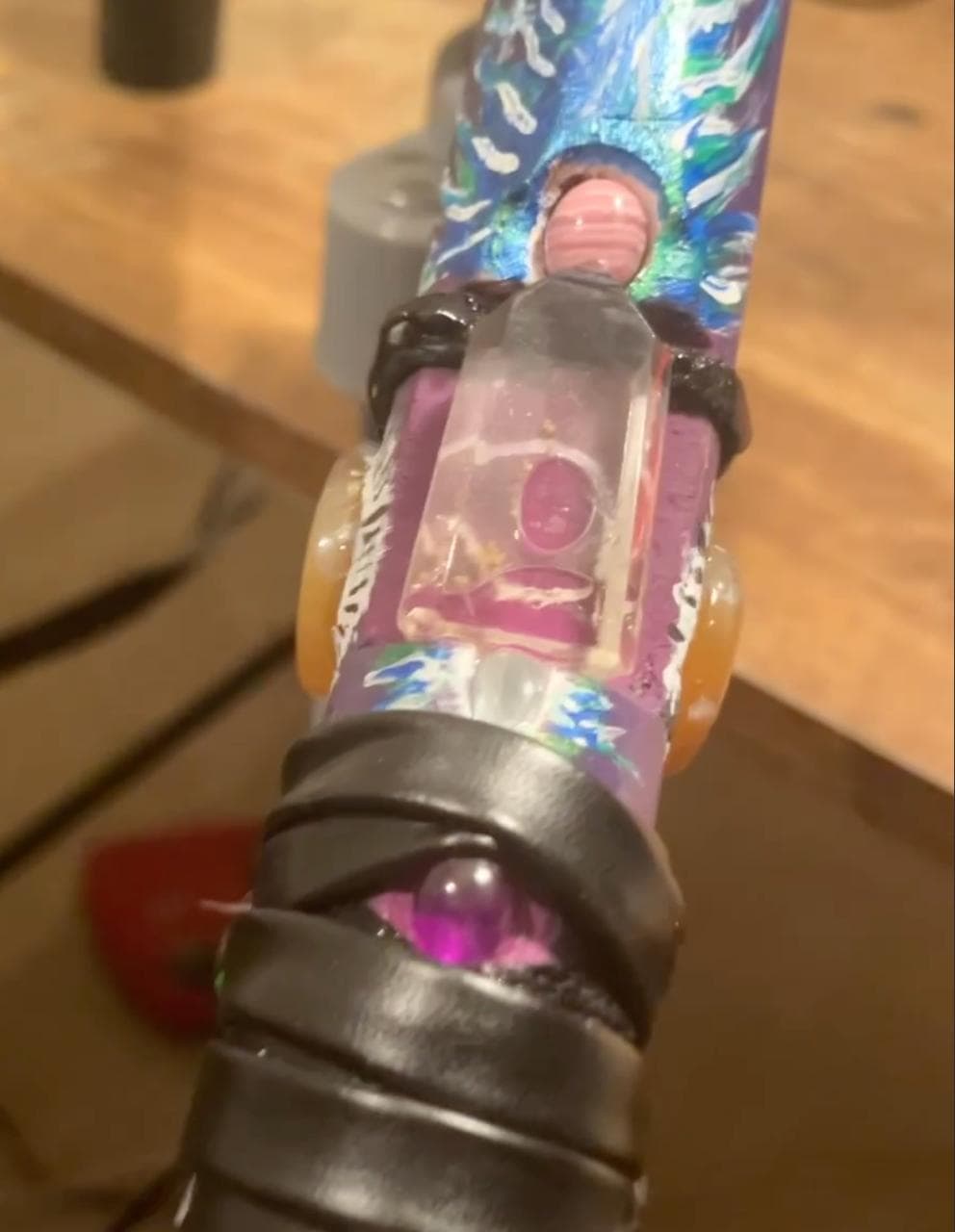 Close-up of pink and clear crystals embedded in a hand painted Spirit Sword